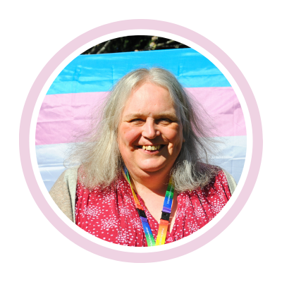 Helen standing in front of a Trans flag