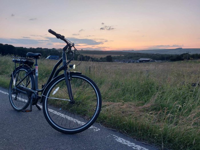 Bicycle in front of a sunset in the countryside