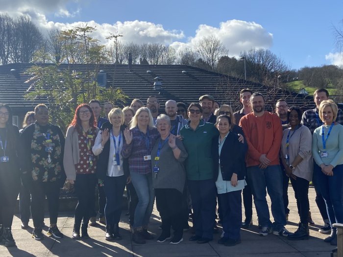 Forest Close team standing together in the sun in a courtyard