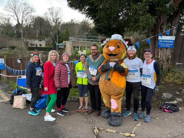 People smiling in Christmas and running gear at charity event