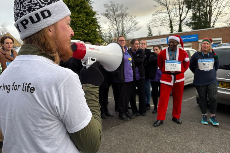 People smiling in Christmas and running gear at charity event