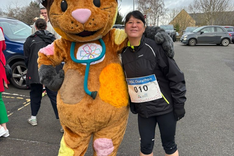 People smiling in Christmas and running gear at charity event