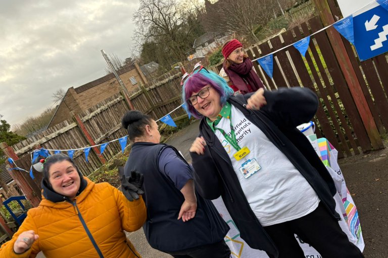 People smiling in Christmas and running gear at charity event