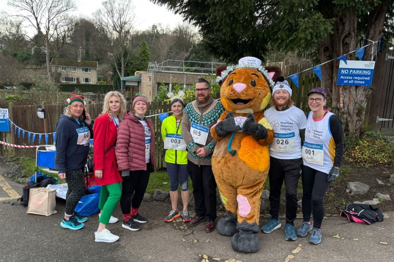 People smiling in Christmas and running gear at charity event