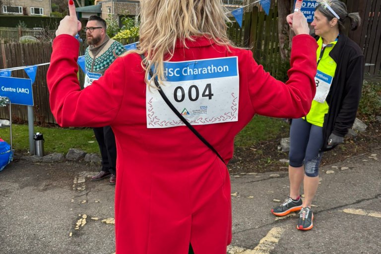 People smiling in Christmas and running gear at charity event