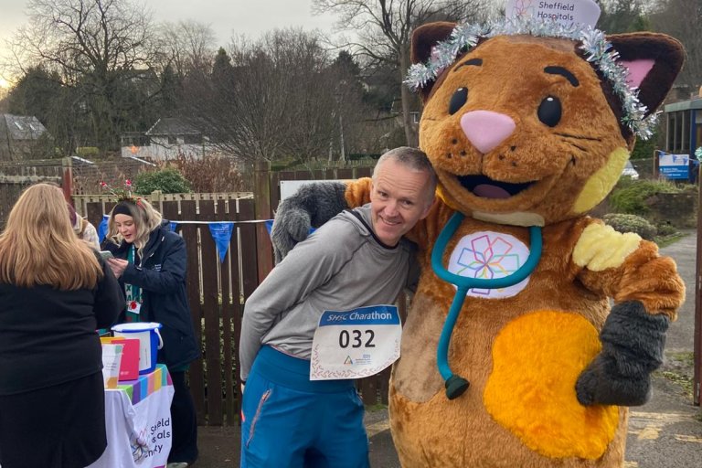 People smiling in Christmas and running gear at charity event