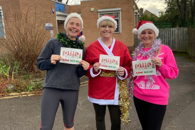 People smiling in Christmas and running gear at charity event